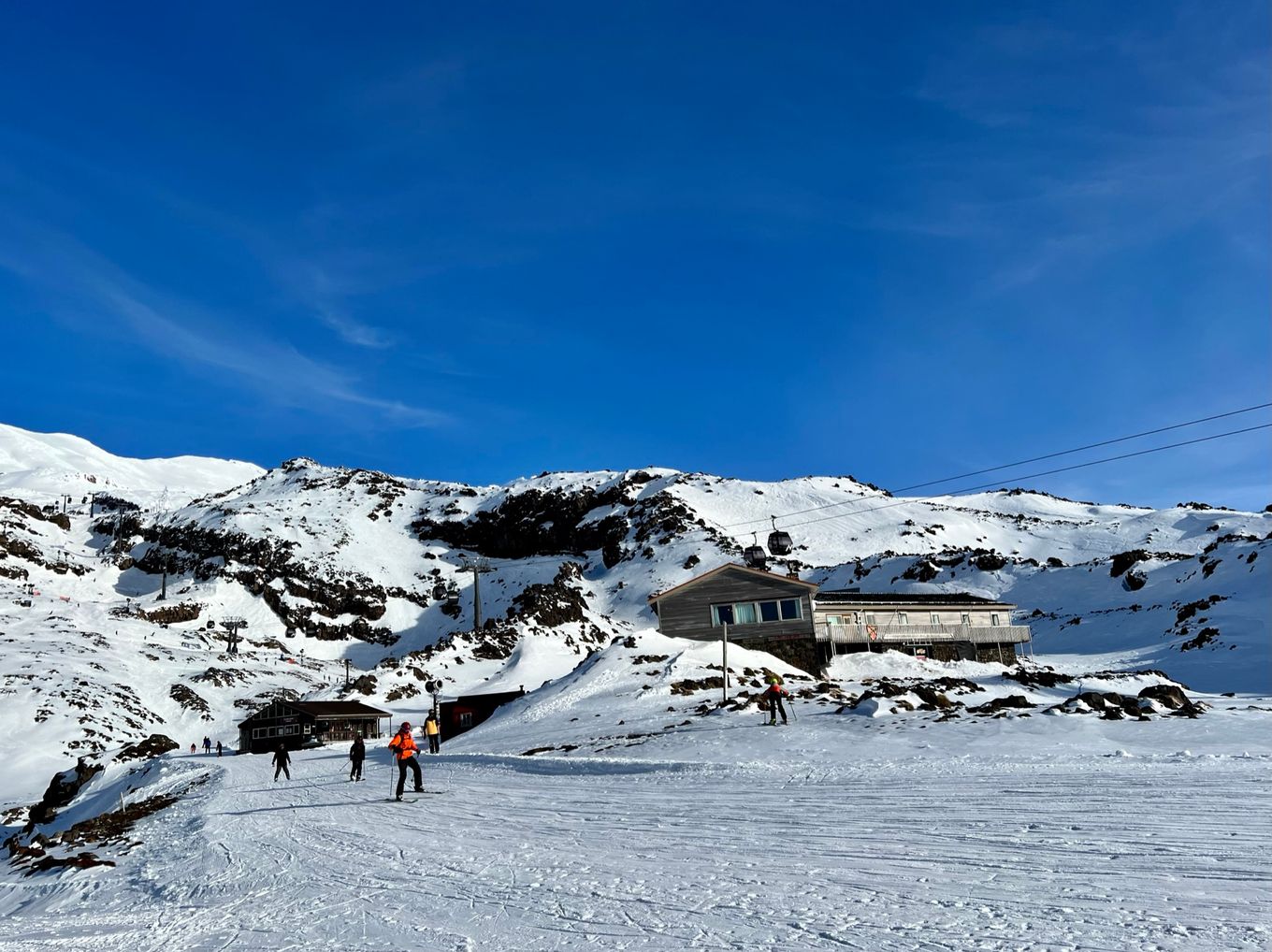 a group of people standing on top of a snow covered slope