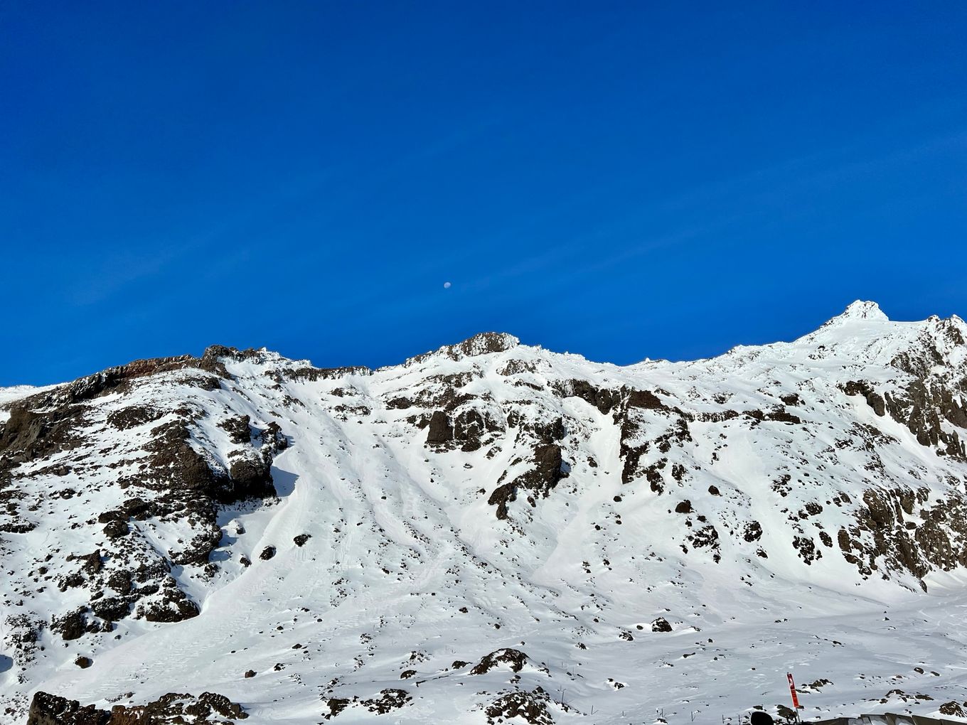 a snow capped view of the crate at the top of Mount Ruapehu.