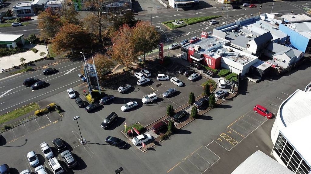 An aerial view of a parking lot with cars parked in it